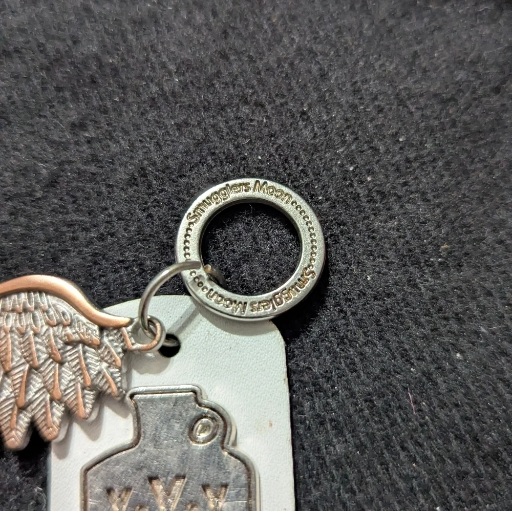 Smuggler's Moon Silver Copper Tone Wing and White Leather Moonshine Tag Keychain